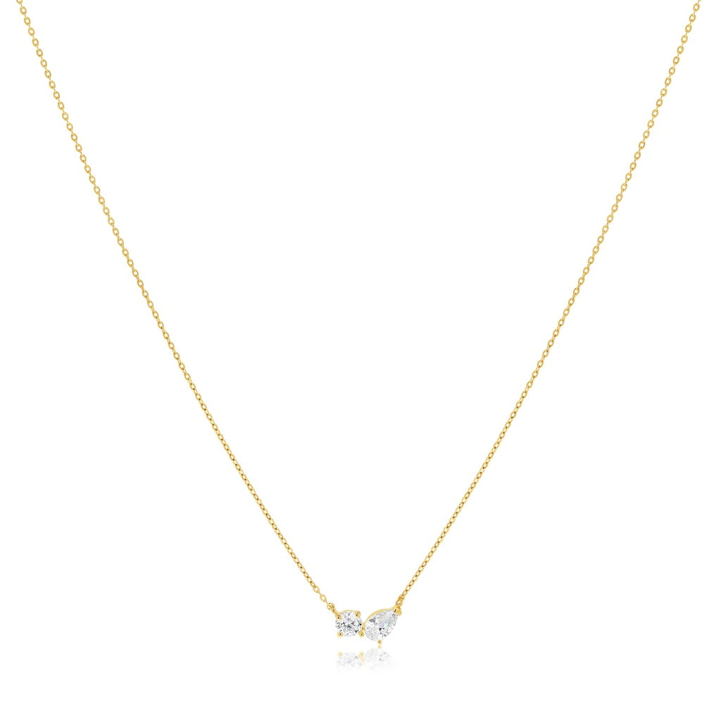 Gold necklace with a small heart-shaped pendant on a white background