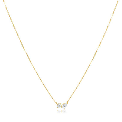 Gold necklace with a small heart-shaped pendant on a white background