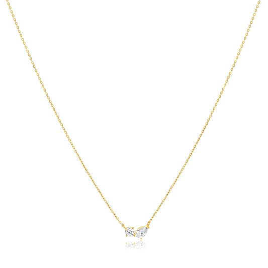Gold necklace with a small heart-shaped pendant on a white background