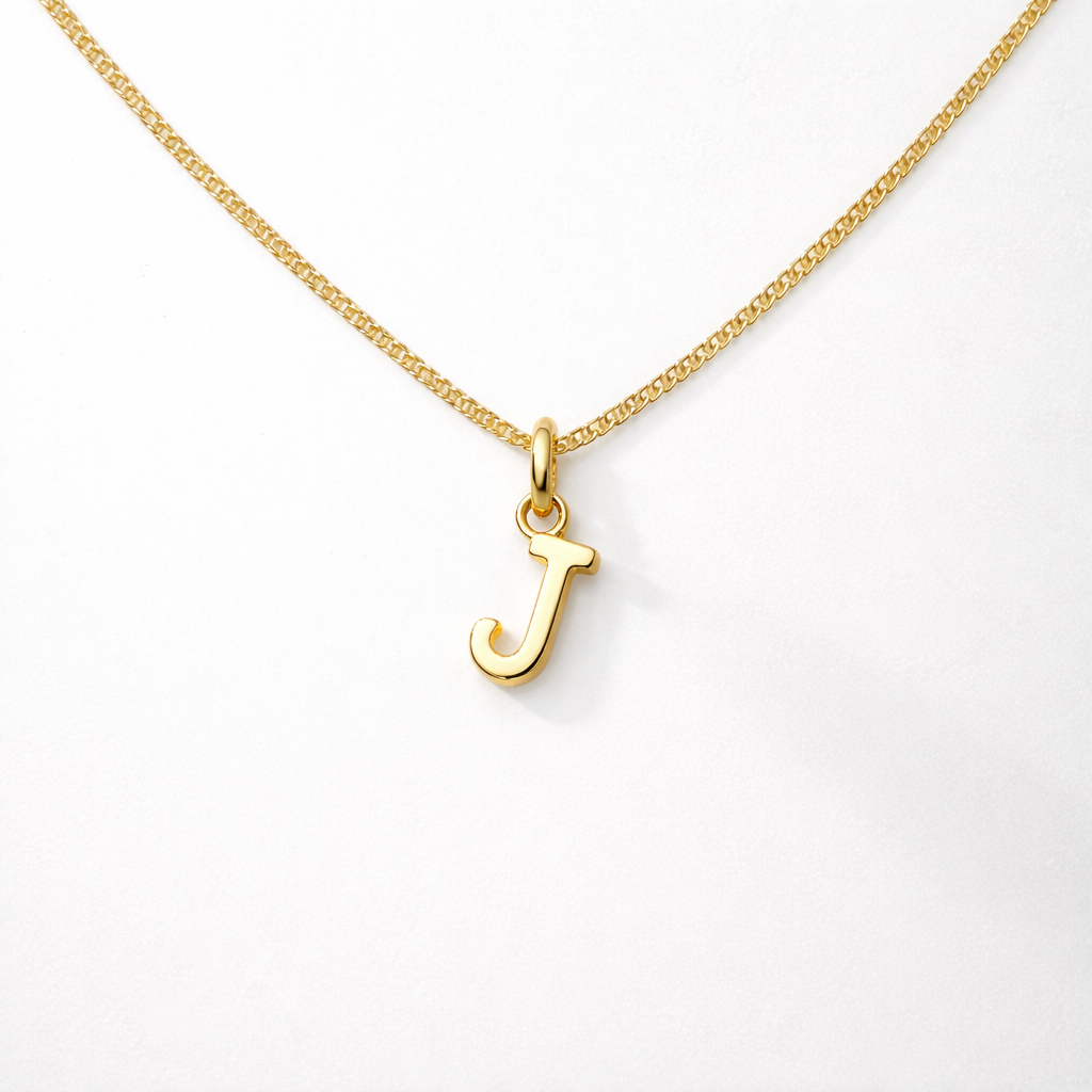 Gold necklace with a 'J' pendant on a white background