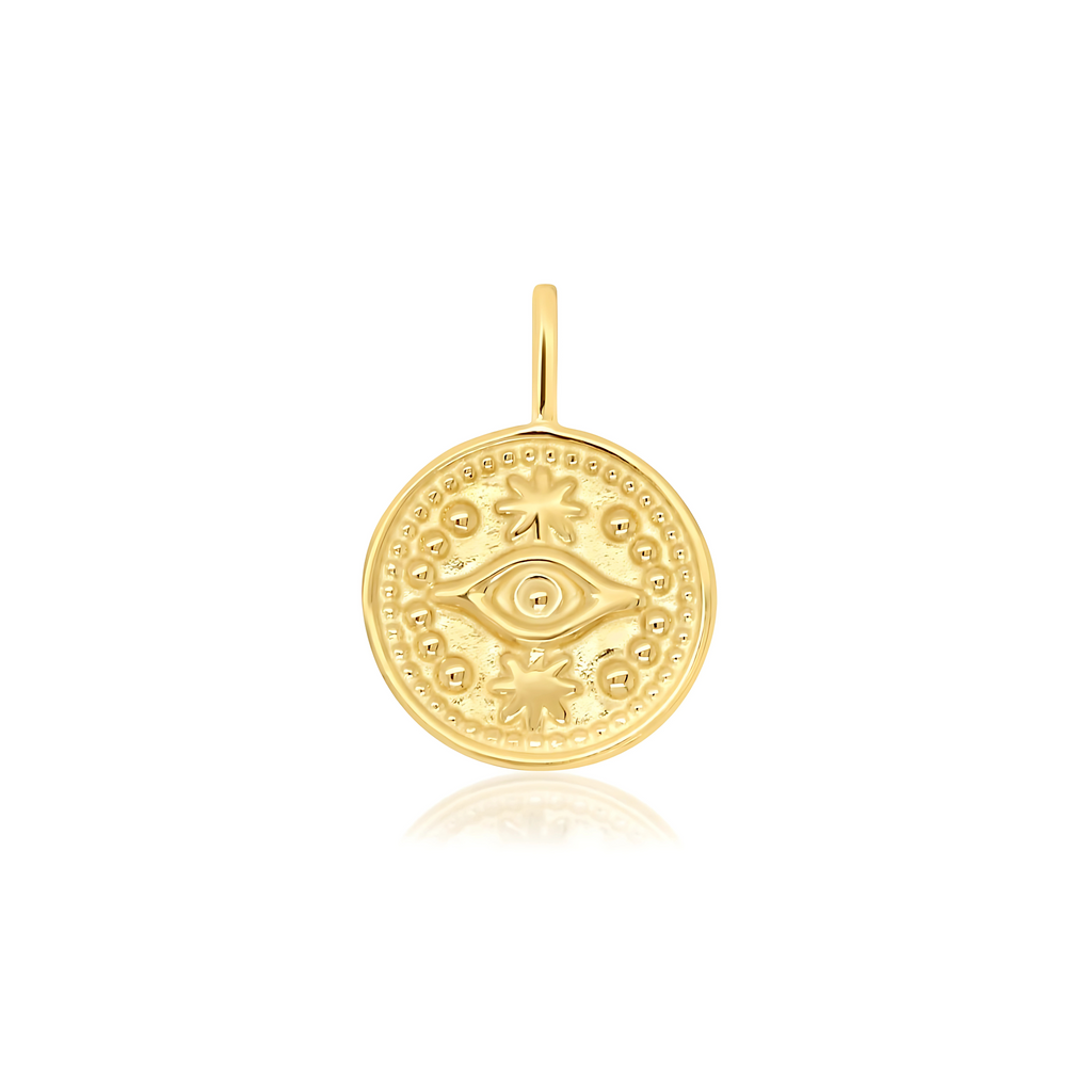 Gold pendant with intricate designs on a white background