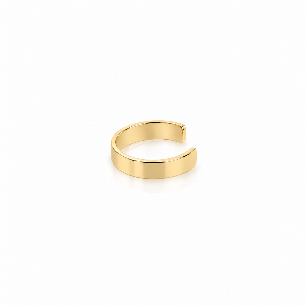 A minimalist, polished gold open cuff ring, also known as a bandillo, shown on a clean white background with a soft reflection underneath.