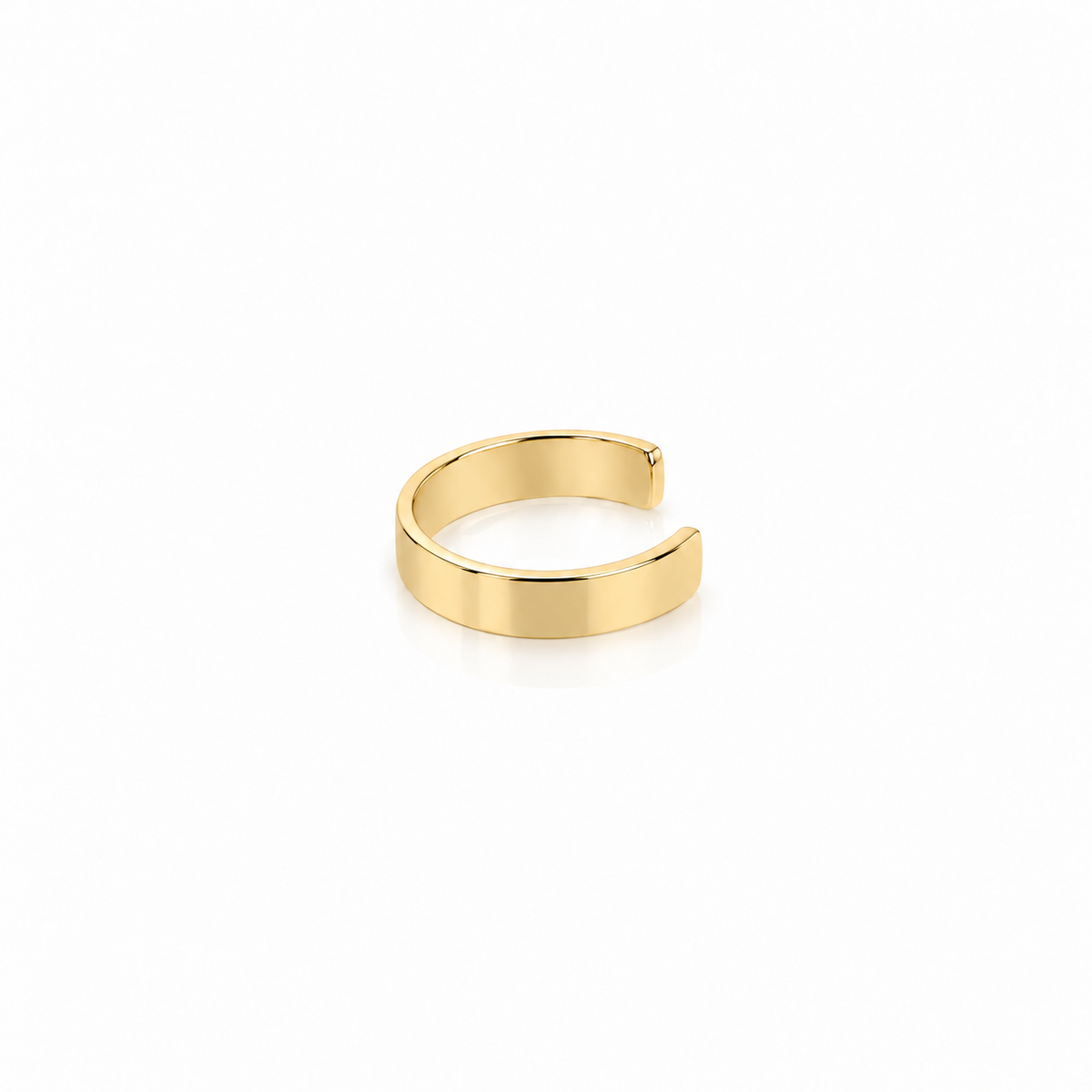 A minimalist, polished gold open cuff ring, also known as a bandillo, shown on a clean white background with a soft reflection underneath.