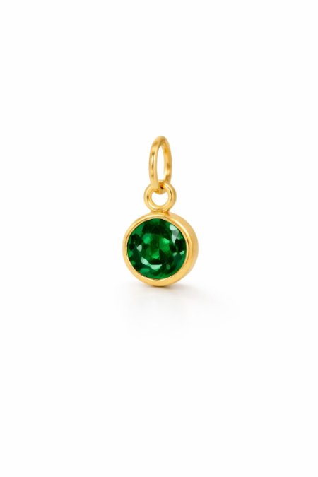 Gold pendant with a green gemstone on a white background