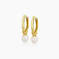 Gold hoop earrings with pearl drops on a white background