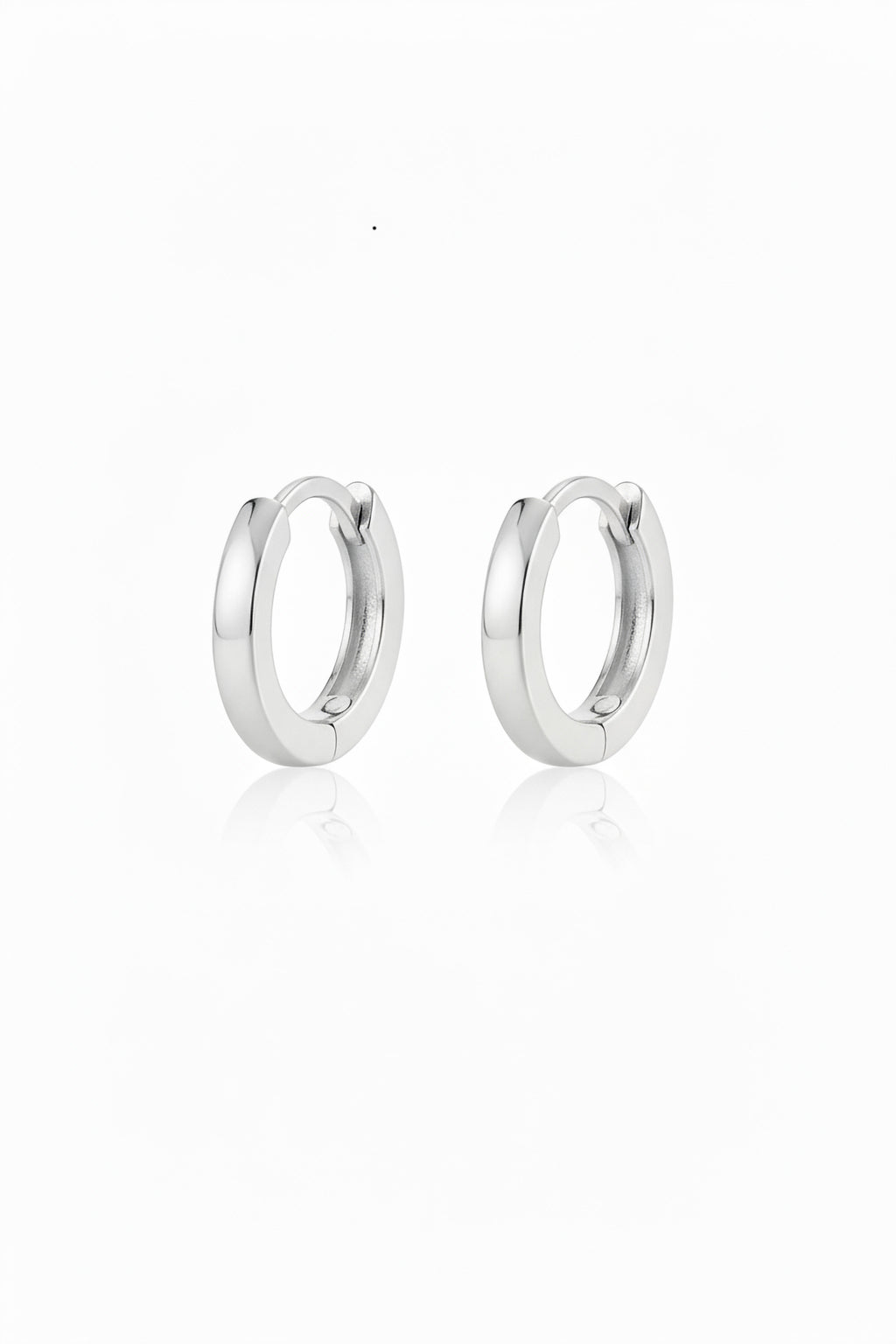 Pair of polished 12mm sterling silver hinged hoop earrings with a soft reflection on a white background