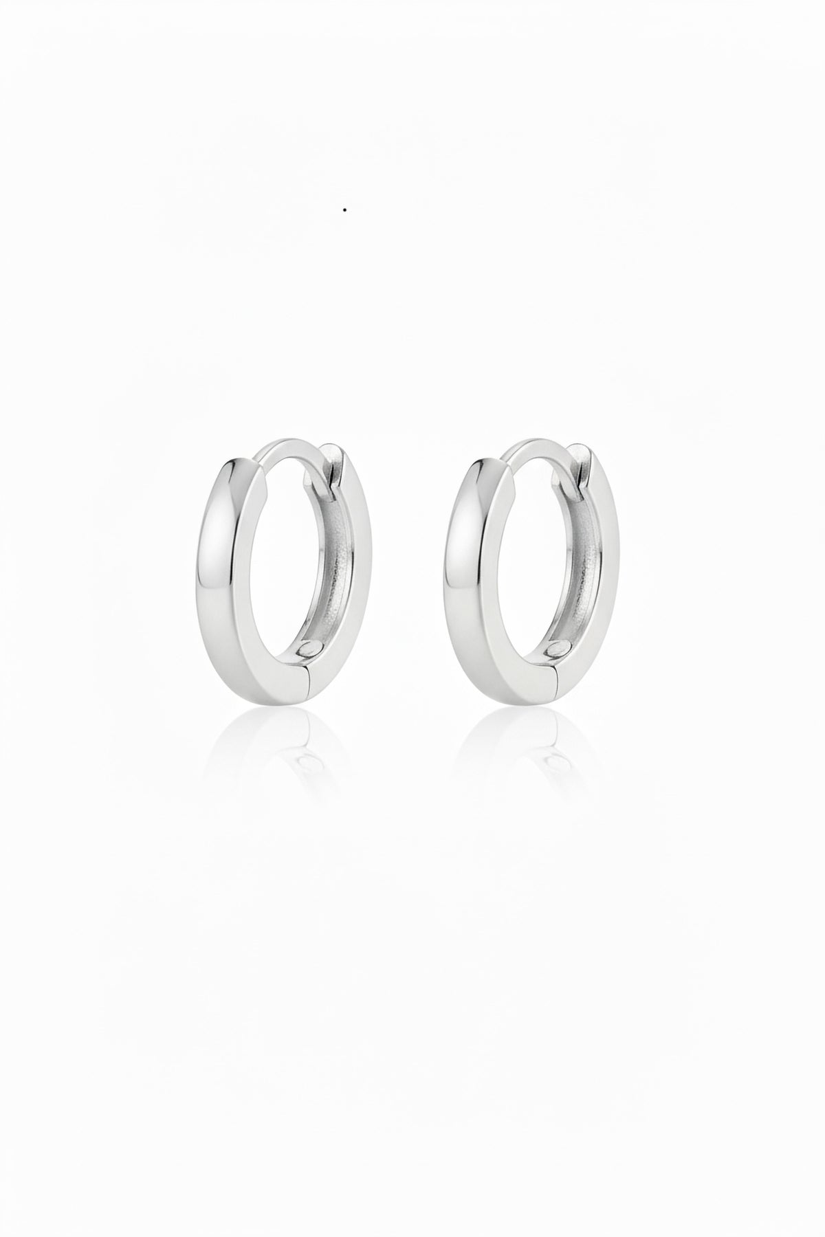 Pair of polished 12mm sterling silver hinged hoop earrings with a soft reflection on a white background
