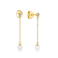 Gold earrings with pearl drops on a white background