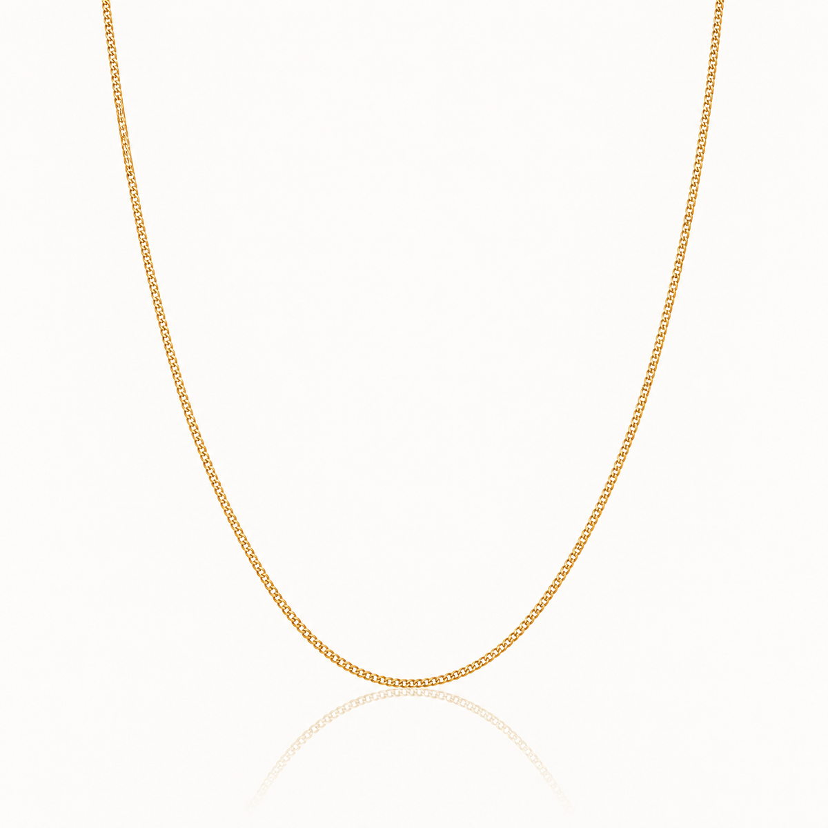 A delicate yellow gold chain necklace displayed in a U-shape against a clean white background with a subtle reflection below.