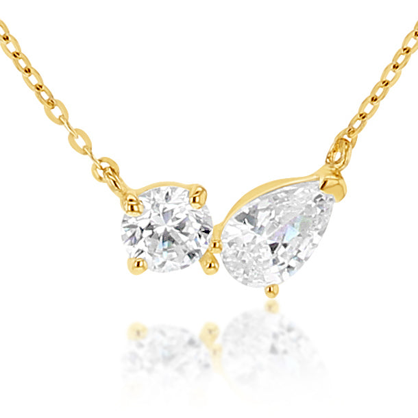 Gold necklace with two diamond pendants on a white background