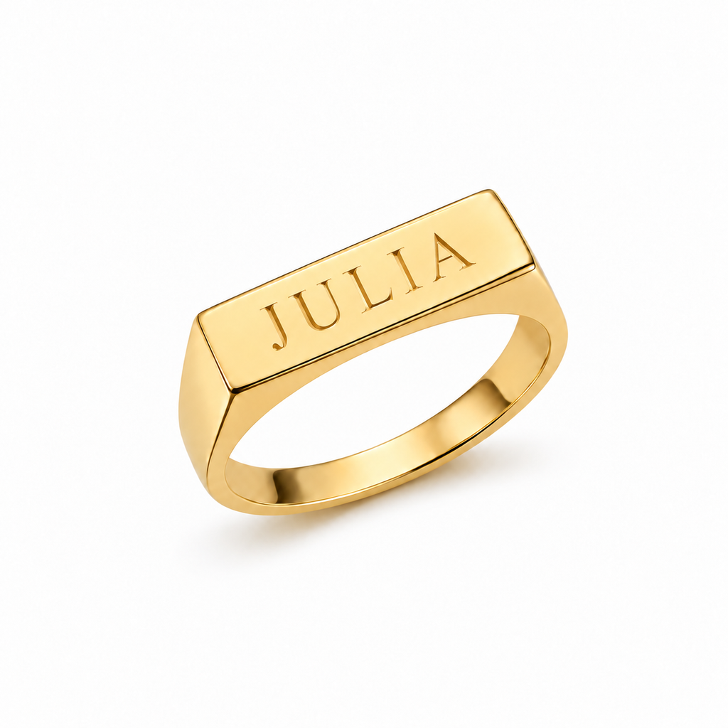 Yellow gold longline signet ring showing JULIA engraved across its rectangular face