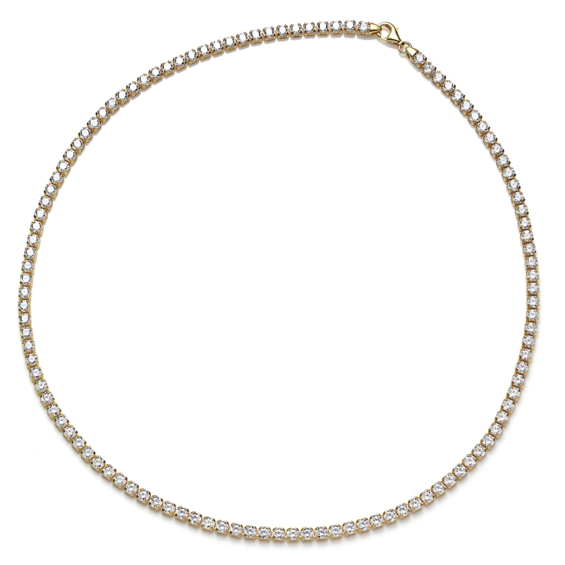 Gold necklace with clear stones on a white background
